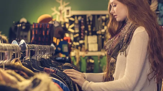 Woman browsing clothes on a rack in a shop