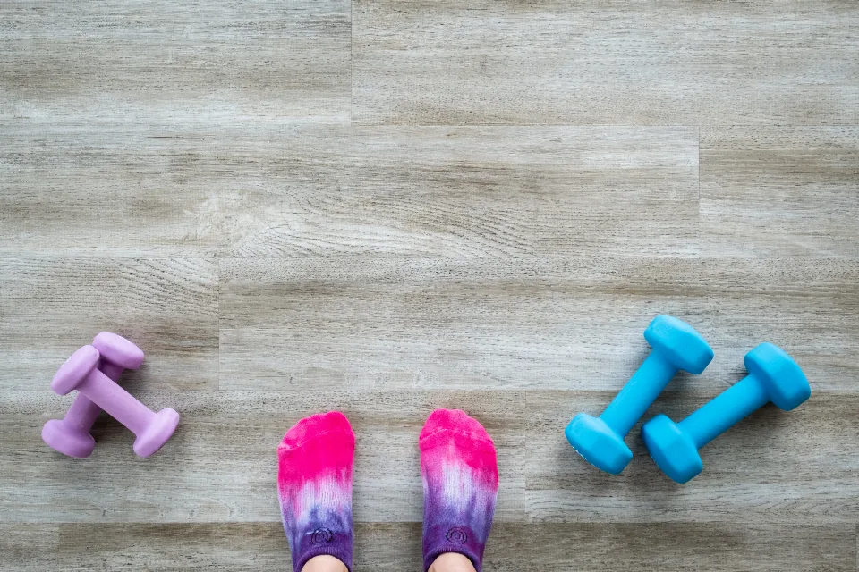 Socks and dumbbells on a wooden floor