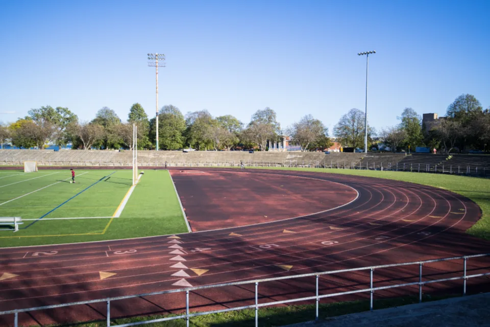 Running track and sports field under a blue sky